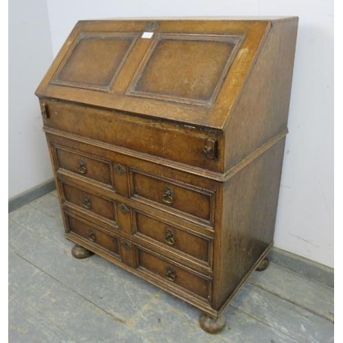 750 - A vintage oak bureau in the William & Mary taste, the fall front opening onto a fitted interior with... 