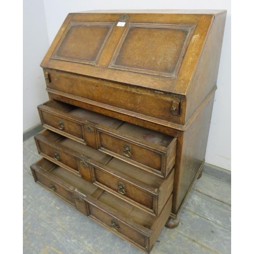 750 - A vintage oak bureau in the William & Mary taste, the fall front opening onto a fitted interior with... 