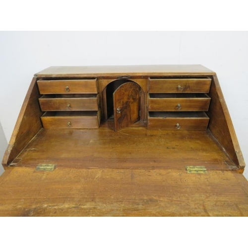 758 - A George III fruitwood bureau, the fall front opening onto a fitted interior with central document s... 