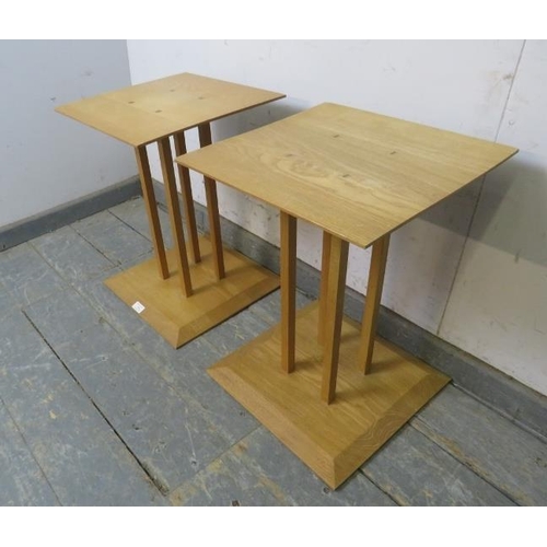 764 - A pair of contemporary light oak square bedside tables, the chamfered tops above cluster columns wit... 