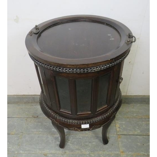 767 - An antique style hardwood circular drinks cabinet, the removable tray top with brass swan-neck handl... 