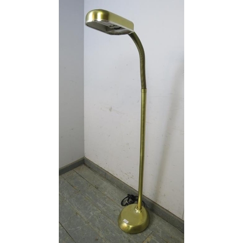 768 - A vintage brushed brass floor-standing reading lamp with adjustable goose neck, on a plinth base.
H1... 