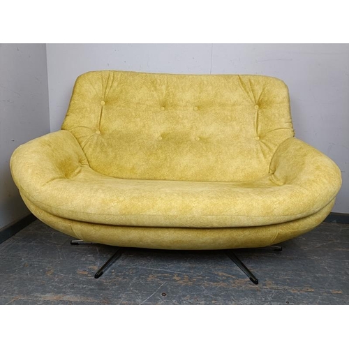 771 - A mid-century two-seater sofa/loveseat, reupholstered in buttoned yellow velvet material, on splayed... 