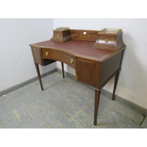 778 - An Edwardian mahogany writing desk, marquetry inlaid & parquetry strung, the rear gallery with brass... 