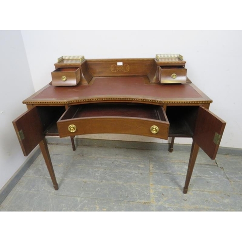 778 - An Edwardian mahogany writing desk, marquetry inlaid & parquetry strung, the rear gallery with brass... 