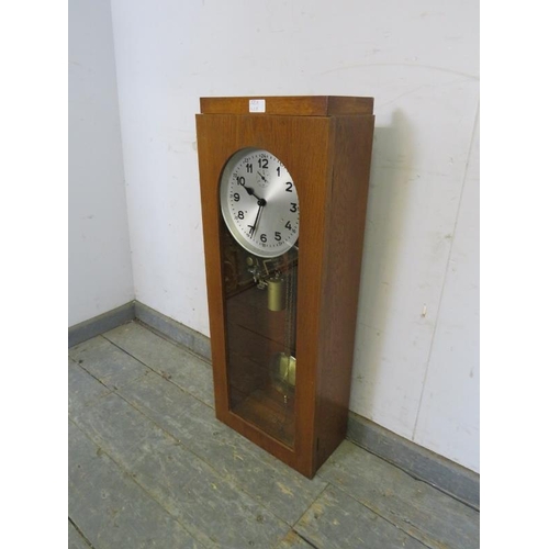 781 - An Art Deco Period light oak cased electric factory master clock, the brushed steel dial with Arabic... 