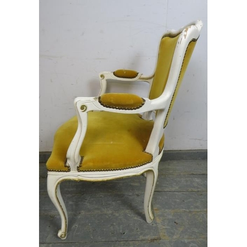 783 - A vintage French open-sided armchair painted in distressed white with gilt accents and upholstered i... 