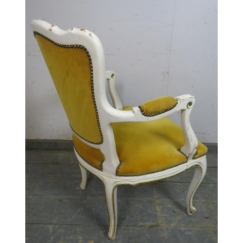 783 - A vintage French open-sided armchair painted in distressed white with gilt accents and upholstered i... 