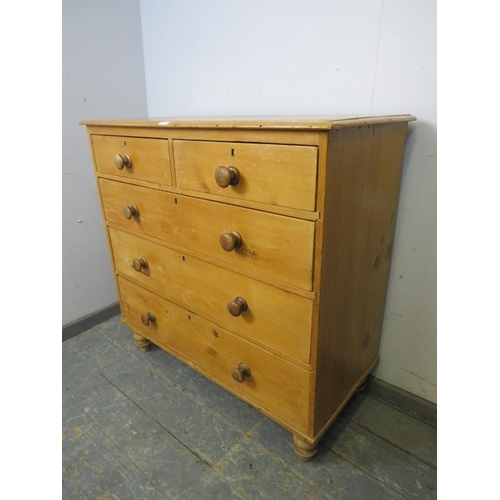 793 - An antique pine chest, housing two short and three long graduated drawers with turned wooden handles... 