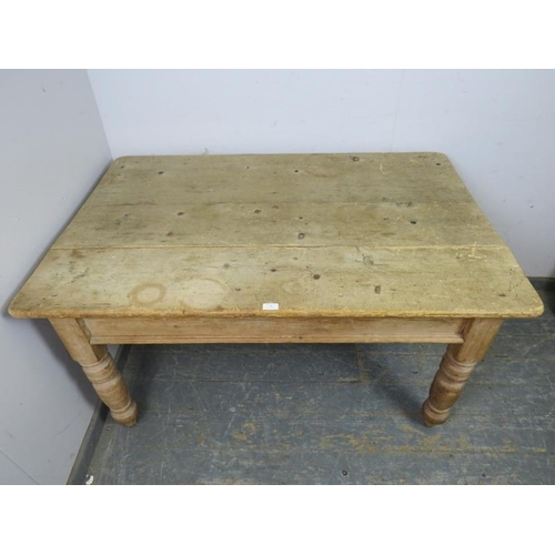 799 - An antique pine farmhouse kitchen table, having one long drawer with cast iron scalloped handles, on... 