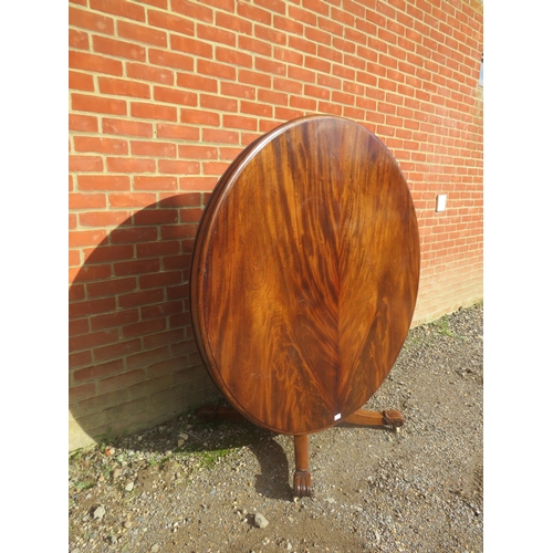 814 - A Victorian flame mahogany tilt-top circular breakfast table, on a turned pedestal with acanthus car... 