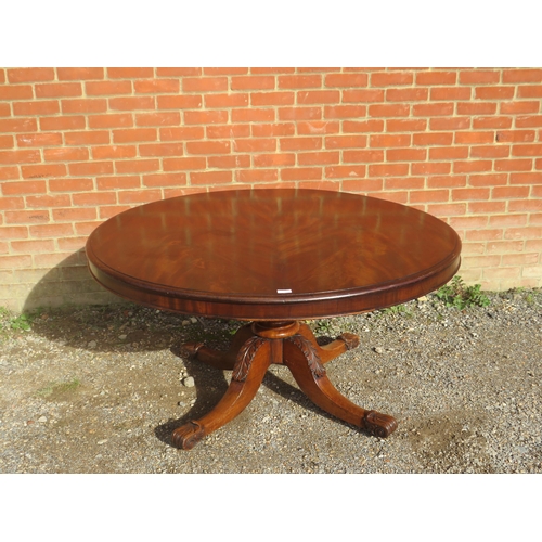 814 - A Victorian flame mahogany tilt-top circular breakfast table, on a turned pedestal with acanthus car... 