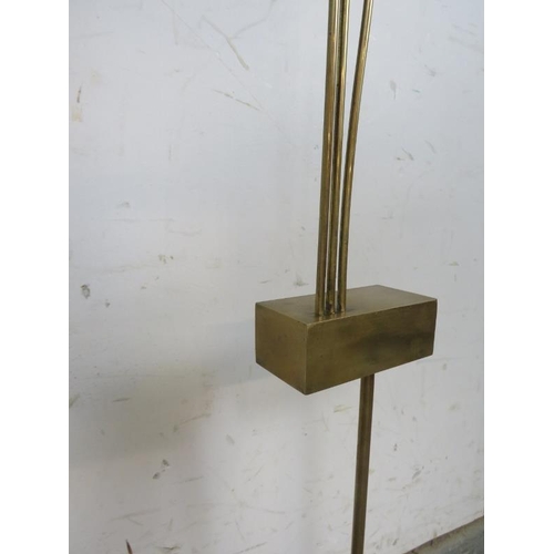 815 - A mid-century brass abstract floor-standing sculpture, on an ebonised weighted plinth base. 
H136cm ... 