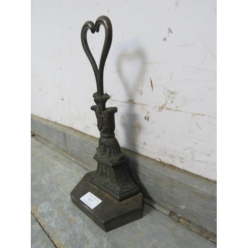 823 - A Victorian bronze and cast-iron door stop, modelled as acanthus leaves surmounted by a pierced hear... 