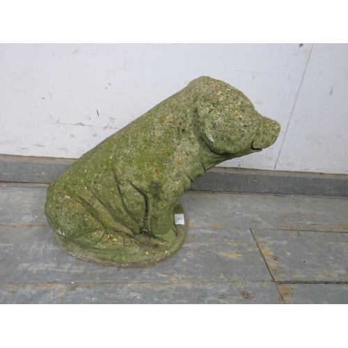 825 - A weathered reconstituted stone garden ornament modelled as a sitting pig. 
H35cm W43cm D22cm approx... 