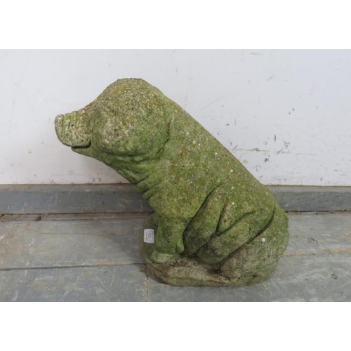 825 - A weathered reconstituted stone garden ornament modelled as a sitting pig. 
H35cm W43cm D22cm approx... 