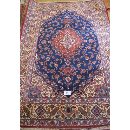 854 - A 20th Century Persian Kashan rug with central motif terracotta on blue ground. 310cm x 210cm approx... 