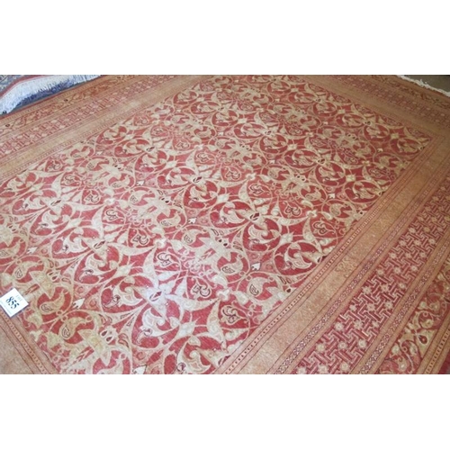 855 - A 20th Century wool carpet central patterned area and wide borders all on red ground. 328cm x 244cm ... 