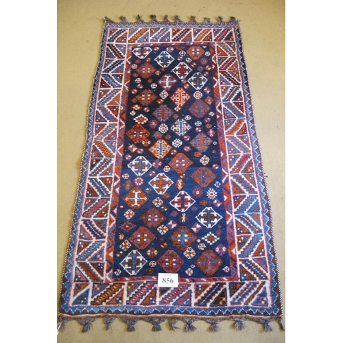 856 - A mid 20th century Afghan rug, thick pile on blue ground. Hand knotted. 210cm x 113cm approx.
Condit... 