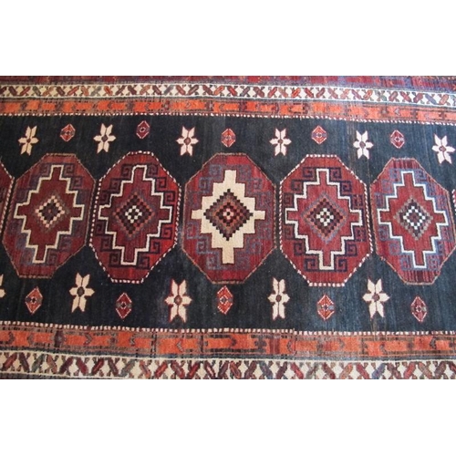 864 - North East Persian Kurdie runner, nine interlocking central motifs with styalised flowers. 280cm x 1... 