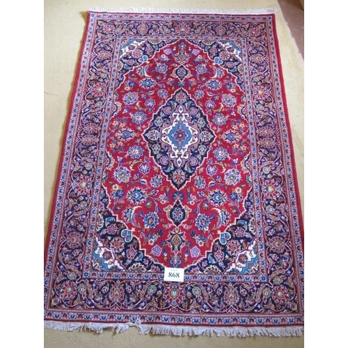 868 - Central Persian Kashan rug. Lovely rug, typical Kashan quality. Blue/cream on red ground. 218cm x 14... 