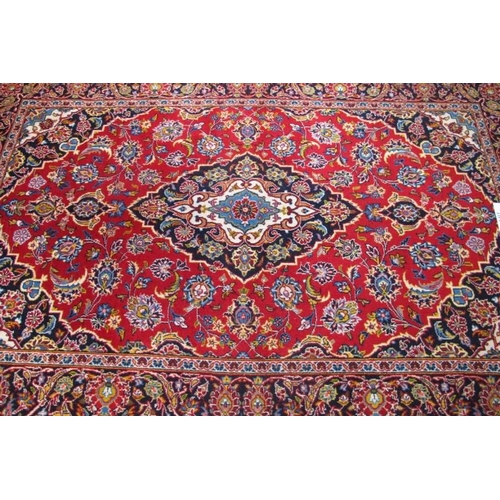 868 - Central Persian Kashan rug. Lovely rug, typical Kashan quality. Blue/cream on red ground. 218cm x 14... 