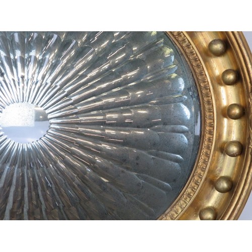 710 - A Regency Period wall mirror/light reflector, the ‘starburst’ moulded plate within an oval gilt gess... 