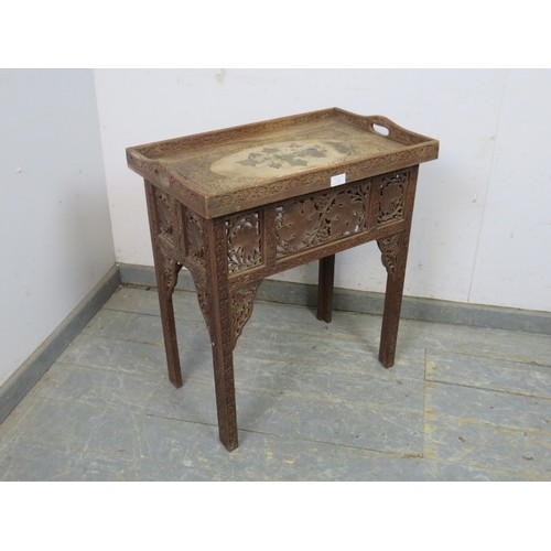 752 - An antique hardwood Anglo Indian table, the galleried tray top relief carved with fruit and vine mot... 