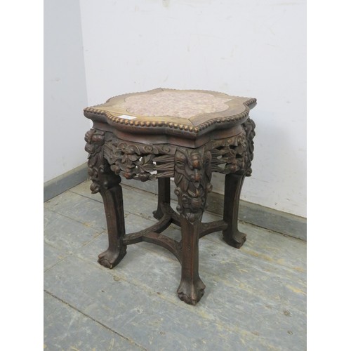 754 - An antique Chinese rosewood plant stand, the shaped top with inset rouge marble, above a carved and ... 