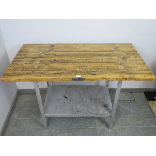 755 - An industrial scaffold table, the planked top with polished boss studs, on a steel base with underti... 