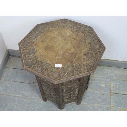 753 - An antique Anglo Indian octagonal occasional table, the top with fruit and vine relief carved border... 