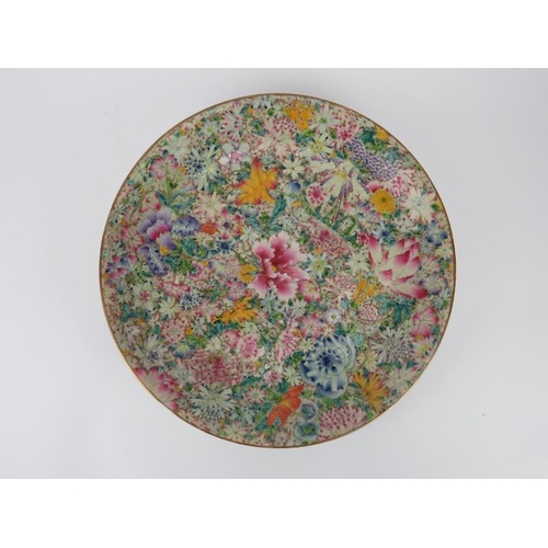 53 - A Chinese famille rose mille fleur charger, 19th century. Profusely decorated with overglaze enamels... 