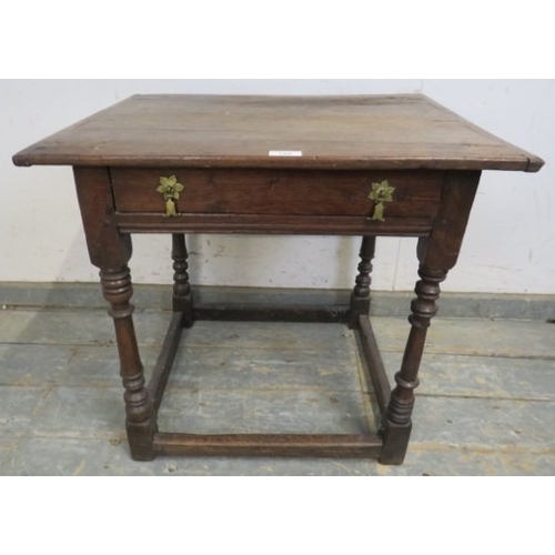 708 - A William and Mary period oak country lowboy with planked top over a frieze drawer and turned legs w... 