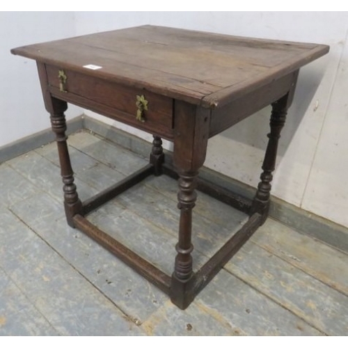 708 - A William and Mary period oak country lowboy with planked top over a frieze drawer and turned legs w... 