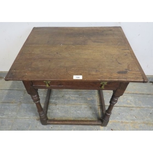 708 - A William and Mary period oak country lowboy with planked top over a frieze drawer and turned legs w... 