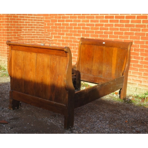 733 - A 19th Century French oak sleigh bed complete with side rails and bolts.  H110cm x W116cm x D208cm a... 