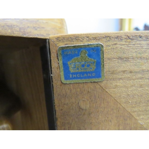 747 - An Ercol sideboard with three cupboard doors over two long drawers, each with dished wooden handles ... 