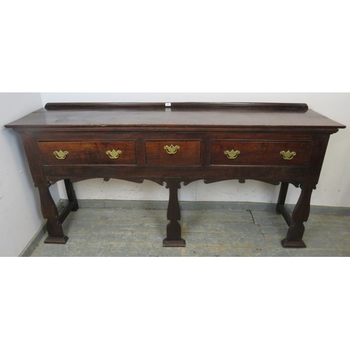 751 - A C1900 mahogany sideboard with three drawers each with brass handles over an ornate six legged supp... 