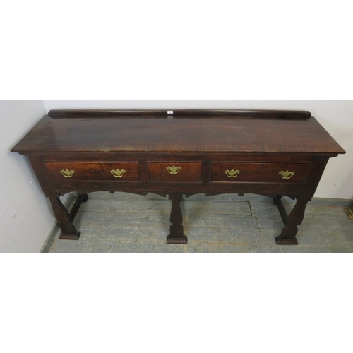 751 - A C1900 mahogany sideboard with three drawers each with brass handles over an ornate six legged supp... 