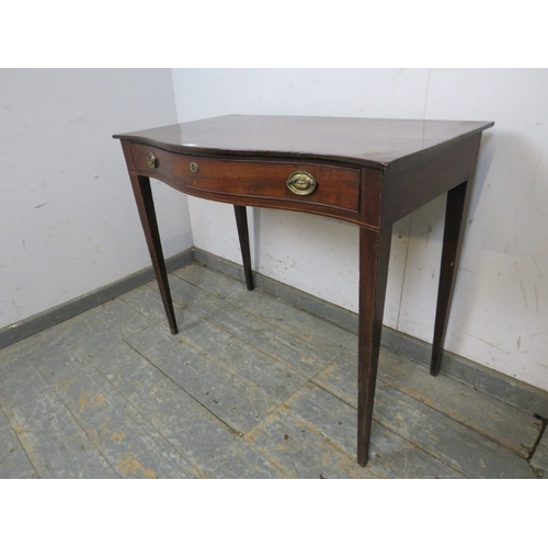 794 - A 19th Century mahogany bow fronted side table with a single frieze drawer.  Brass oval handles and ... 