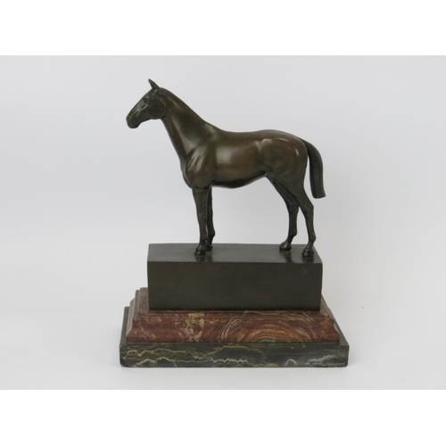 24 - A bronze horse statue, signed ‘Andre’, 20th century. Mounted on a red and black marble base. 21.7 cm... 