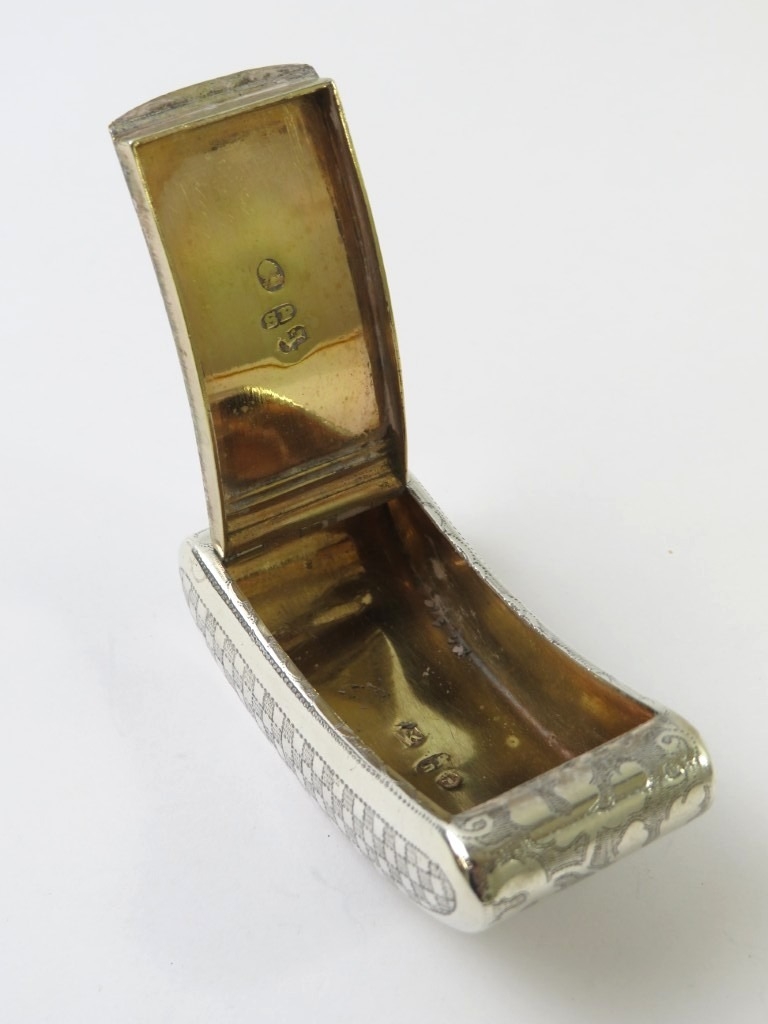 A George III curved silver snuff box with foliate and chequer engraved ...