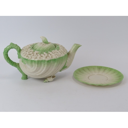 56 - A Belleek ‘Neptune’ shell decorated teapot and a matching saucer. Teapot: 20.8 cm length.
Condition ... 