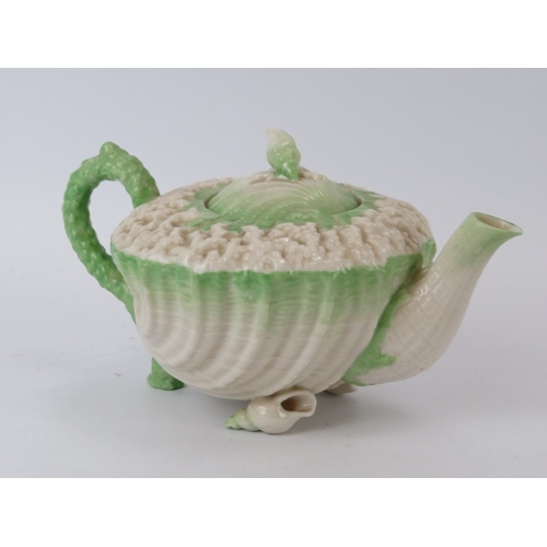 56 - A Belleek ‘Neptune’ shell decorated teapot and a matching saucer. Teapot: 20.8 cm length.
Condition ... 