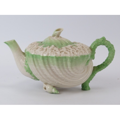 56 - A Belleek ‘Neptune’ shell decorated teapot and a matching saucer. Teapot: 20.8 cm length.
Condition ... 
