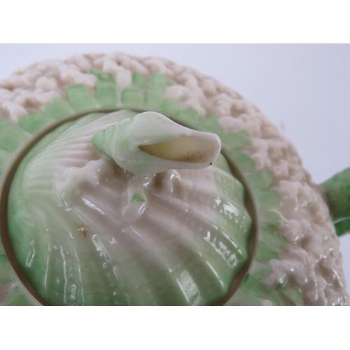 56 - A Belleek ‘Neptune’ shell decorated teapot and a matching saucer. Teapot: 20.8 cm length.
Condition ... 