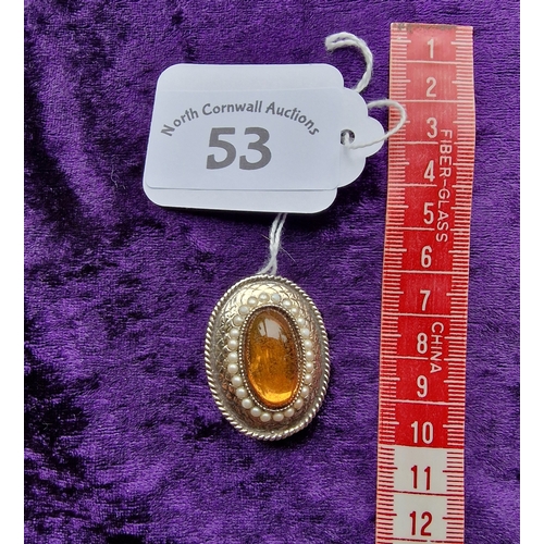 53 - Oval orange stone brooch