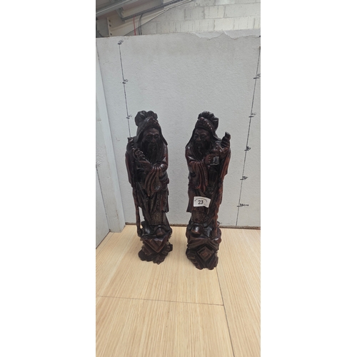 23 - Pair of antique Chinese carved wooden with silver inlaid figures representing deities such as Shou L... 