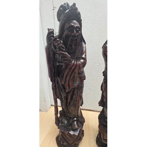 23 - Pair of antique Chinese carved wooden with silver inlaid figures representing deities such as Shou L... 