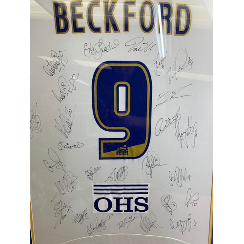 33 - Jermaine Beckford Leeds United Shirt with hand signed autographs from many of the Leeds United Team